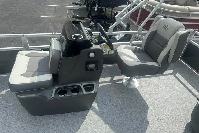 Slide: The Image of 2026 Sun Tracker Bass Buggy 18 DLX pontoon boat interior with dual seats and steering console. - 8
