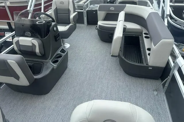 Slide: The Image of 2026 Sun Tracker Bass Buggy 18 DLX pontoon boat interior with gray seating and helm. - 5