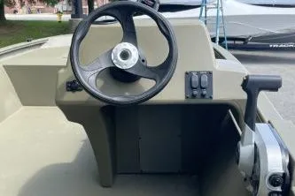 Slide: The Image of 2026 Tracker Grizzly 1648 SC boat steering console with controls and wheel. - 4