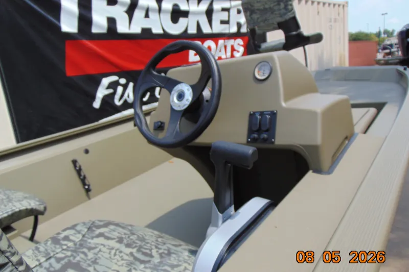 Slide: The Image of 2026 Tracker Grizzly 1754 SC boat interior with steering wheel and controls. - 18