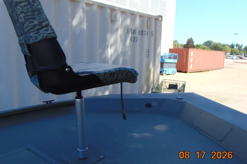 Slide: The Image of Boat seat on a 2026 Tracker Grizzly 1754 SC, near shipping containers. - 34