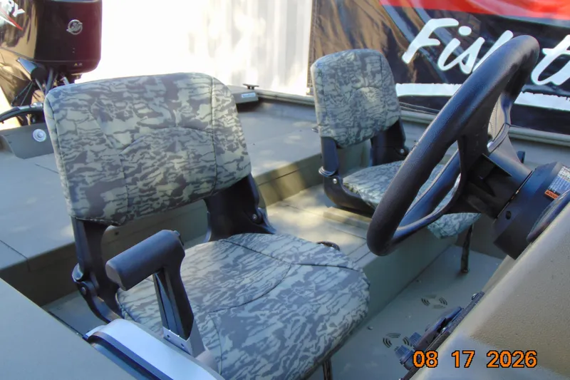 Slide: The Image of Interior of 2026 Tracker Grizzly 1754 SC boat with camo seats and steering wheel. - 17