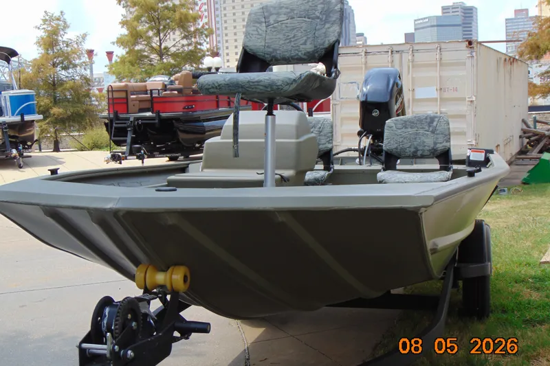 Slide: The Image of 2026 Tracker Grizzly 1754 SC boat on trailer, urban background, sunny day. - 24