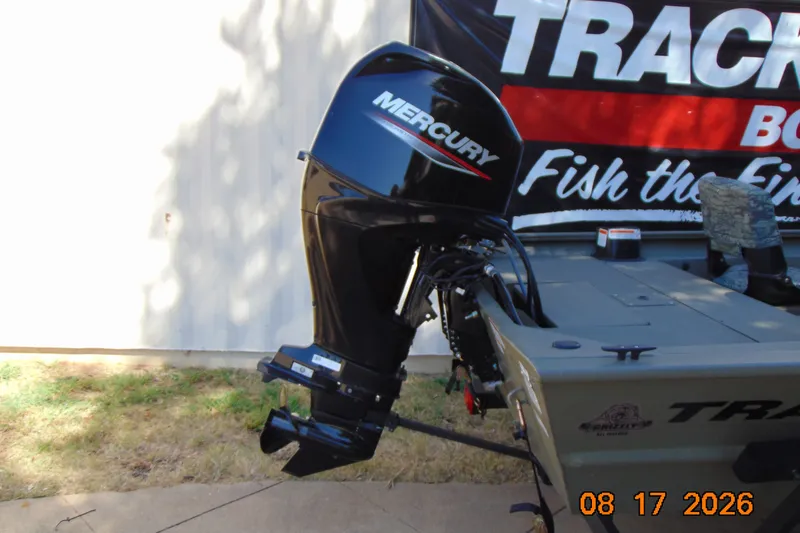 Slide: The Image of 2026 Tracker Grizzly 1754 SC boat with Mercury outboard motor displayed outdoors. - 27