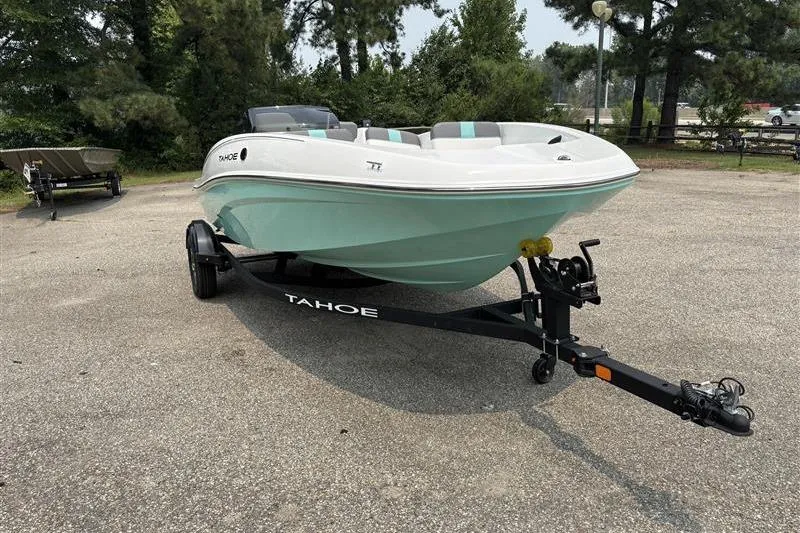 Slide: The Image of 2026 Tahoe T16 boat on trailer in outdoor setting, featuring sleek design and mint green hull. - 6
