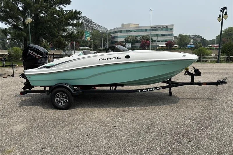 Slide: The Image of 2026 Tahoe T16 boat on trailer in parking lot, side view. - 7