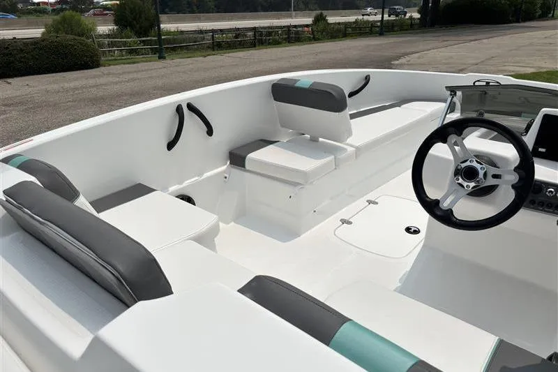 Slide: The Image of 2026 Tahoe T16 boat interior with sleek seating and modern steering wheel design. - 13