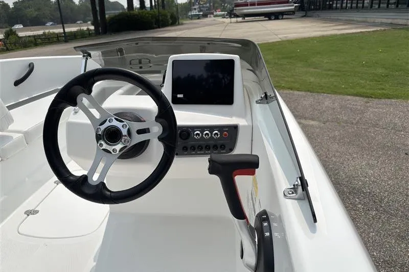 Slide: The Image of 2026 Tahoe T16 boat dashboard with steering wheel and control panel. - 10
