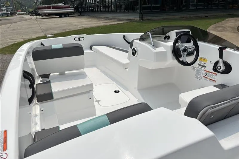 Slide: The Image of 2026 Tahoe T16 boat interior with modern seating and steering wheel design. - 12