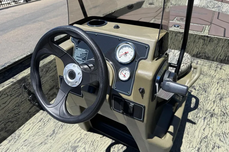 Slide: The Image of Steering console of 2026 Tracker Grizzly 1860 CC boat with gauges and controls. - 6