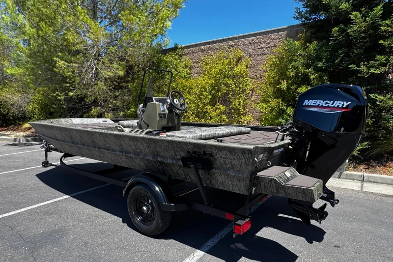 Slide: The Image of 2026 Tracker Grizzly 1860 CC boat with Mercury engine in parking lot. - 3