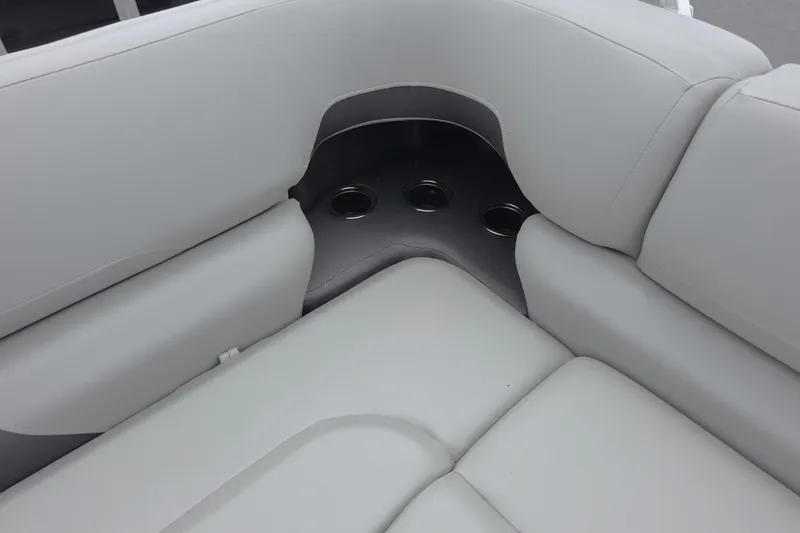 Slide: The Image of 2026 Sun Tracker SportFish 22 XP3 boat interior with cushioned seating and cup holders. - 12