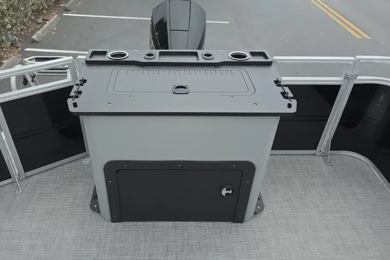 Slide: The Image of 2026 Sun Tracker SportFish 22 XP3 boat deck with storage compartment and cup holders. - 13