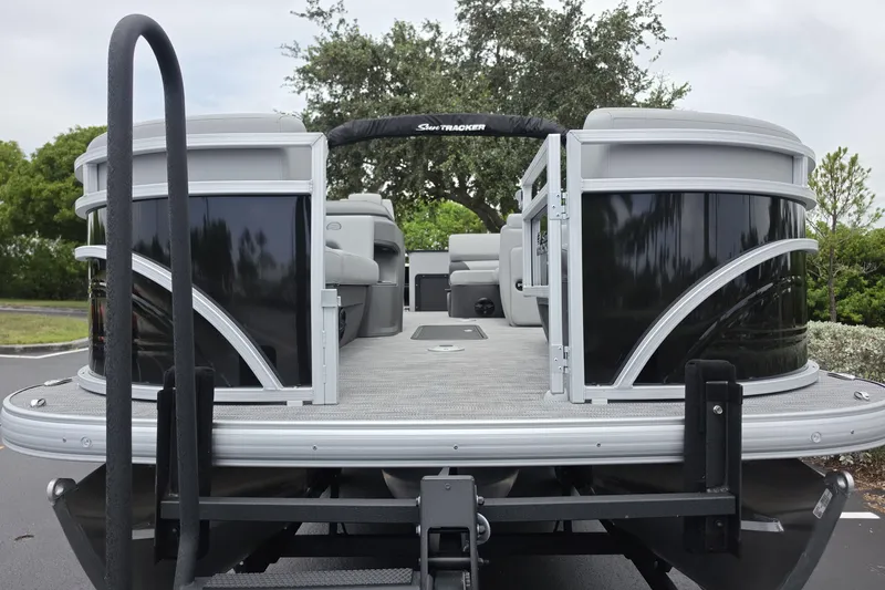 Slide: The Image of 2026 Sun Tracker SportFish 22 XP3 pontoon boat, rear view, on a trailer. - 3