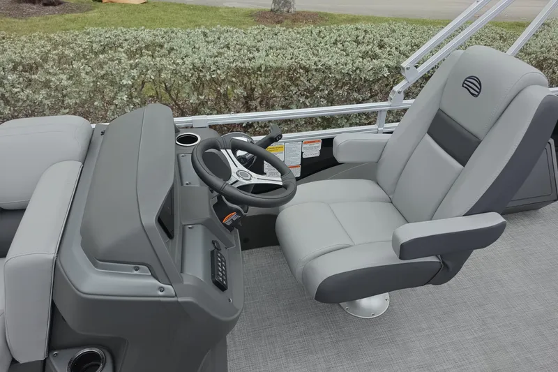 Slide: The Image of 2026 Sun Tracker SportFish 22 XP3 boat interior with steering wheel and captain's chair. - 7