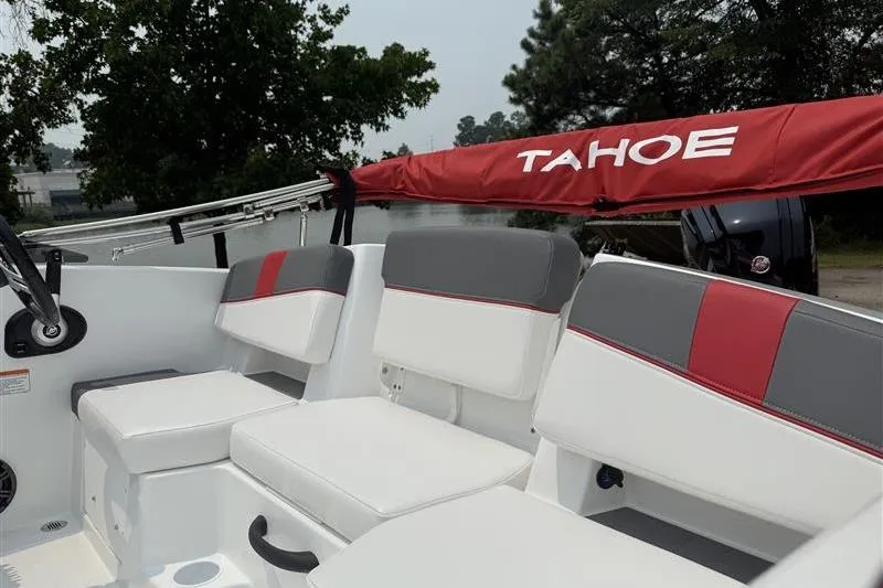 Slide: The Image of 2026 Tahoe T18 boat interior with white and gray seating, red accents, and branded cover. - 10