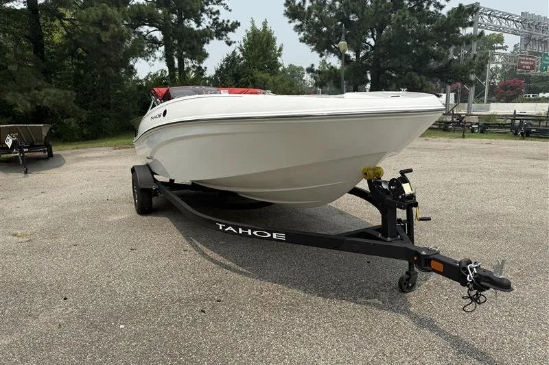 Slide: The Image of 2026 Tahoe T18 boat on trailer in outdoor setting, surrounded by trees. - 3