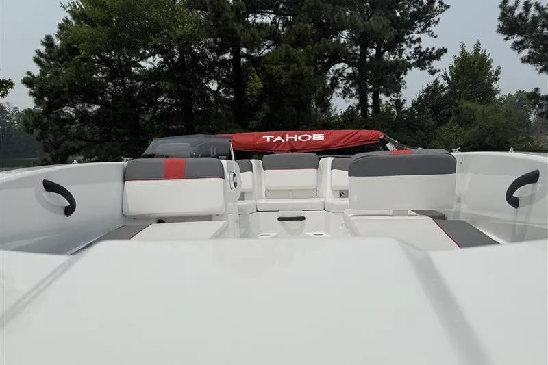 Slide: The Image of 2026 Tahoe T18 boat interior with seating, surrounded by trees. - 8