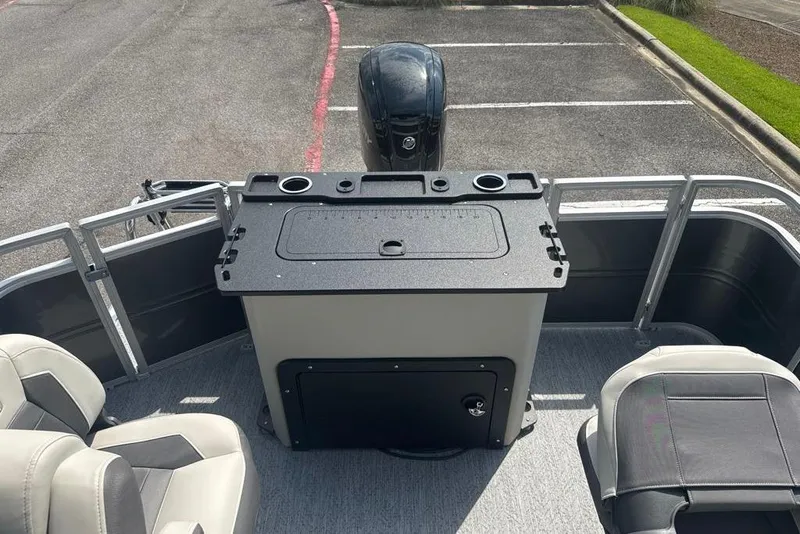 Slide: The Image of 2026 Sun Tracker Fishin' Barge 20 DLX interior with seating and control panel. - 8