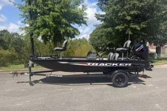 The Image of 2026 Tracker Pro 170 boat on trailer, parked outdoors, surrounded by trees. - 0