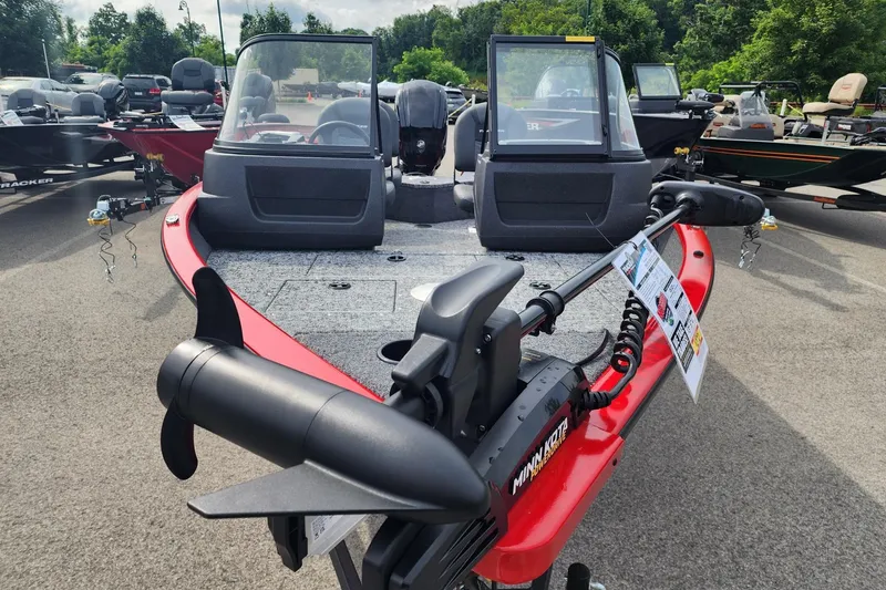 Slide: The Image of 2026 Tracker Pro Guide V-16 WT boat with Minn Kota motor, displayed outdoors. - 2