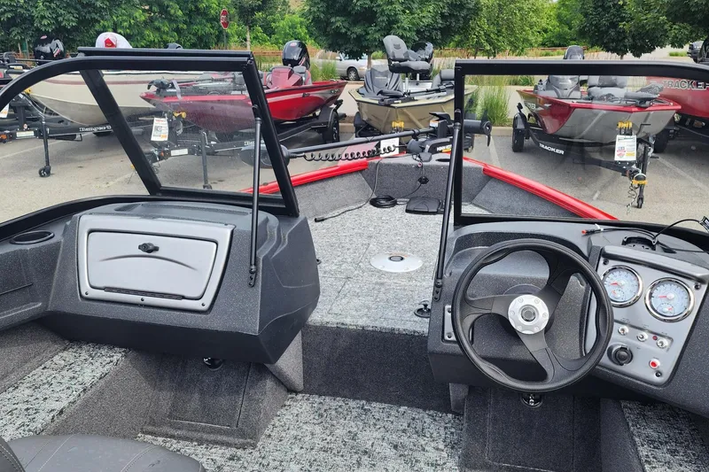Slide: The Image of 2026 Tracker Pro Guide V-16 WT boat interior with steering wheel and dashboard controls. - 3