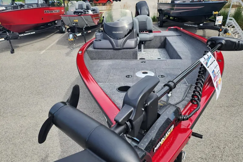 Slide: The Image of 2026 Tracker Super Guide V-16 SC boat with red exterior and advanced trolling motor. - 2