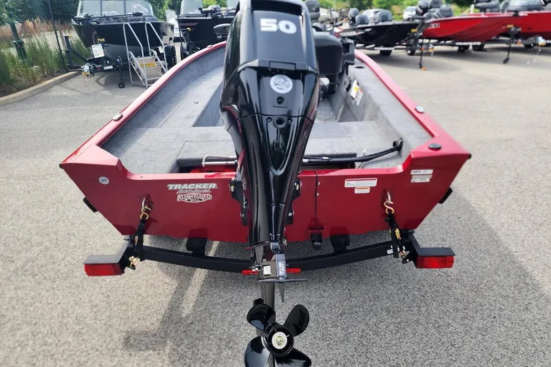 Slide: The Image of 2026 Tracker Super Guide V-16 SC boat with a 50 HP motor, parked on a trailer. - 4