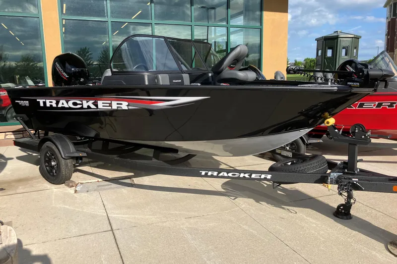 The Image of 2026 Tracker Pro Guide V-175 Combo boat on display, black exterior, parked on trailer. - 0