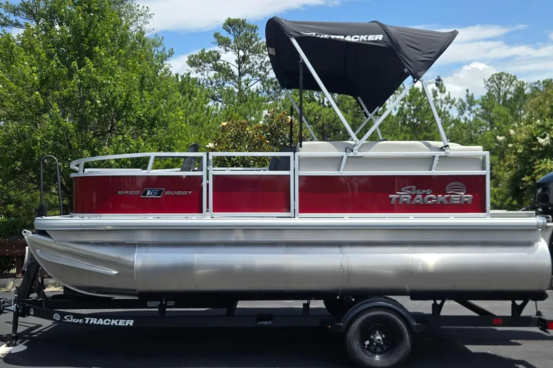 The Image of 2026 Sun Tracker Bass Buggy 16 XL Select pontoon boat with canopy on trailer. - 0