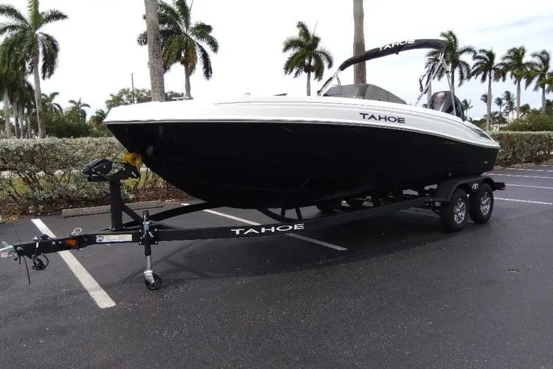 Slide: The Image of 2026 Tahoe T21 boat on trailer in parking lot with palm trees. - 4