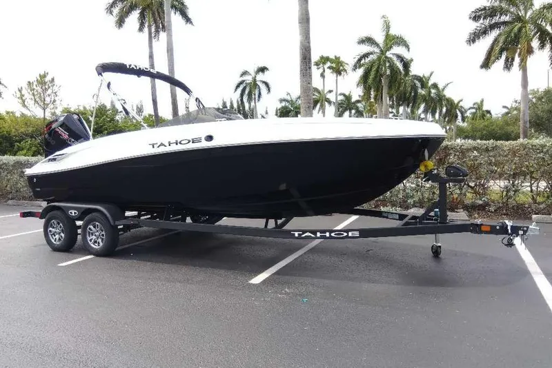 Slide: The Image of 2026 Tahoe T21 boat on trailer in parking lot with palm trees. - 3