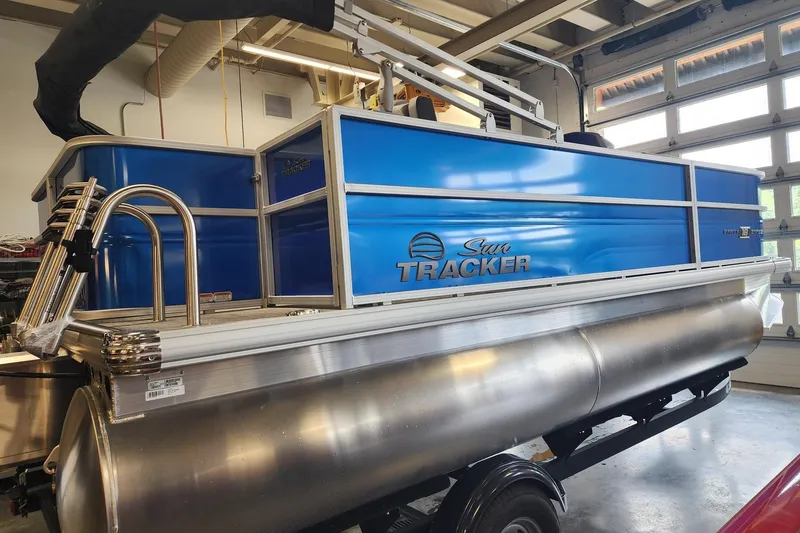 The Image of 2026 Sun Tracker Party Barge 18 DLX pontoon boat in a garage setting. - 0
