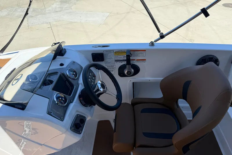 Slide: The Image of Steering console of 2026 Tahoe 1950 boat with modern controls and comfortable seating. - 12