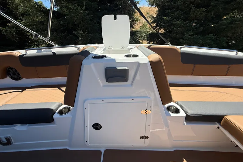 Slide: The Image of Interior of 2026 Tahoe 1950 boat with tan and black seating, cup holders, and storage compartment. - 13