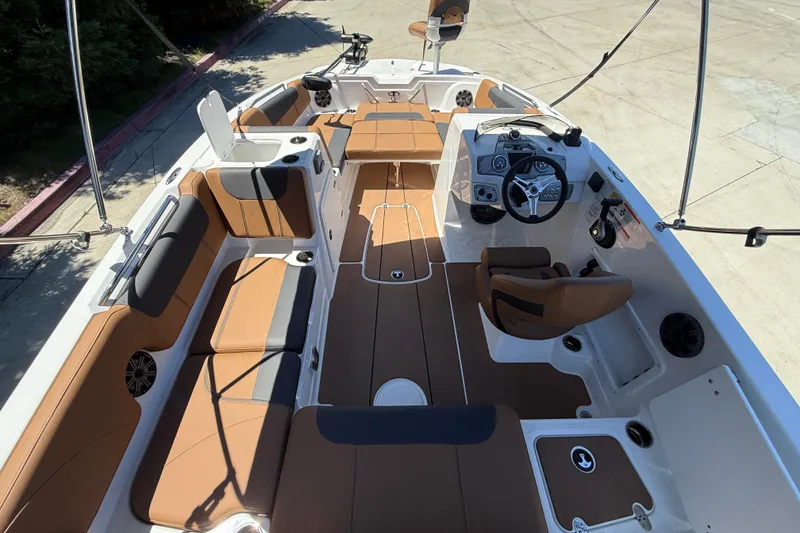 Slide: The Image of 2026 Tahoe 1950 boat interior with brown seating and modern steering console. - 6