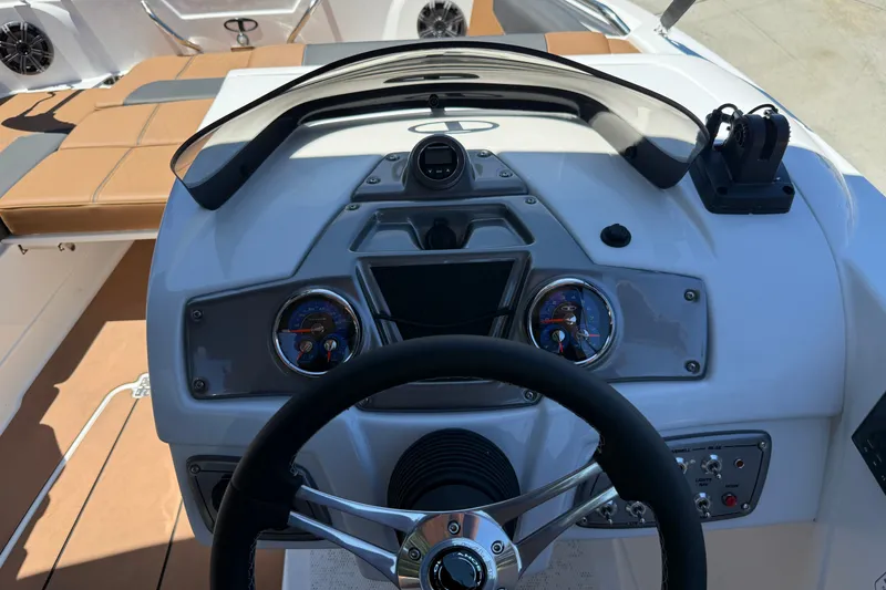 Slide: The Image of Cockpit view of 2026 Tahoe 1950 boat with modern steering and dashboard controls. - 9
