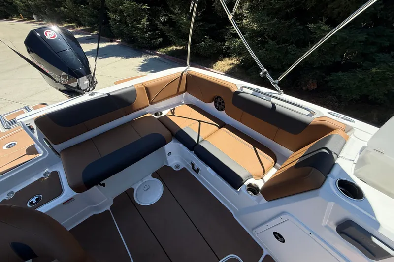 Slide: The Image of Interior of a 2026 Tahoe 1950 boat with brown and black seating. - 17