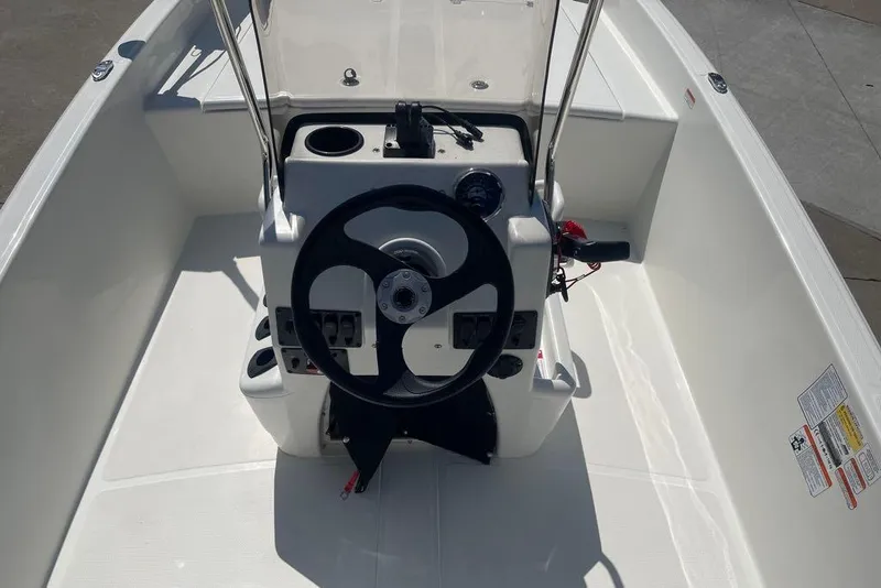 Slide: The Image of 2026 Mako Pro Skiff 17 CC boat console with steering wheel and controls. - 3