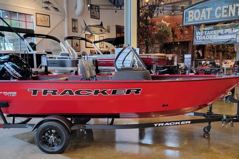 The Image of 2026 Tracker Pro Guide V-16 WT boat displayed in showroom, vibrant red color. - 0