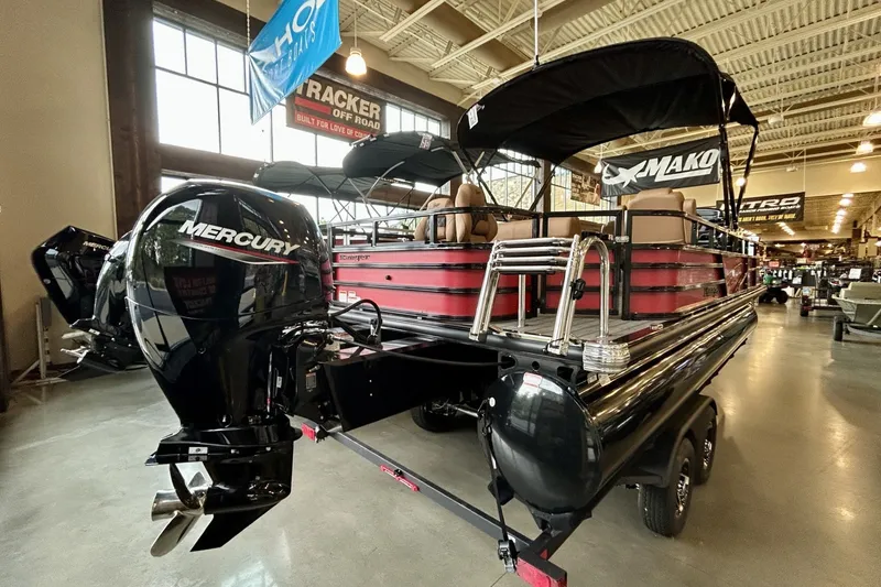 Slide: The Image of 2026 Ranger 220F pontoon boat with Mercury engine displayed indoors. - 5