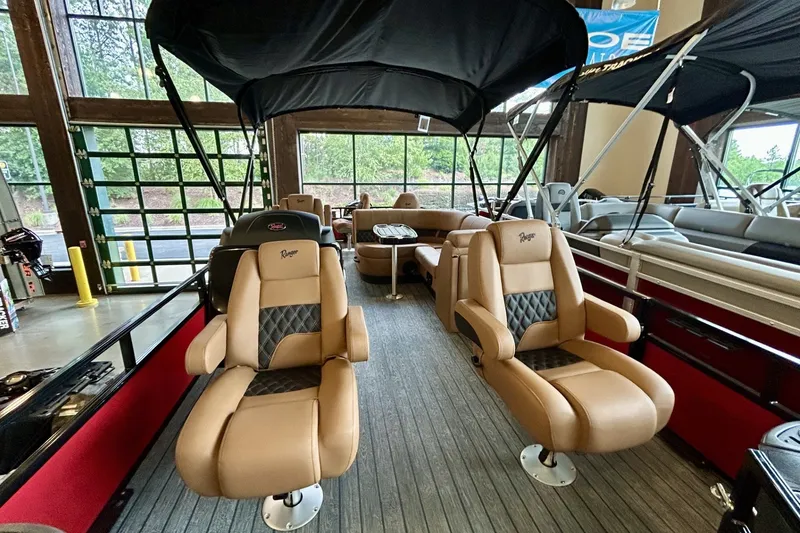 Slide: The Image of 2026 Ranger 220F boat interior with tan leather seats and canopy. - 69