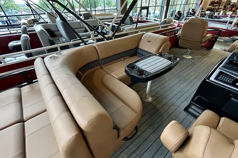 Slide: The Image of 2026 Ranger 220F boat interior with beige seating and a central table. - 2