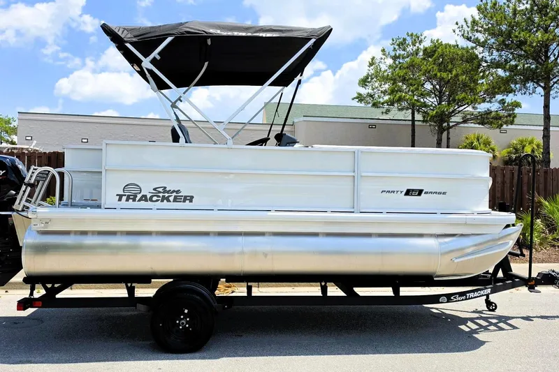 The Image of 2026 Sun Tracker Party Barge 18 DLX pontoon boat with canopy on trailer. - 0