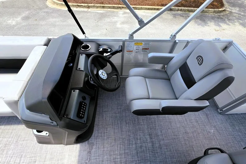 Slide: The Image of 2026 Sun Tracker Party Barge 18 DLX interior with steering console and captain's chair. - 10