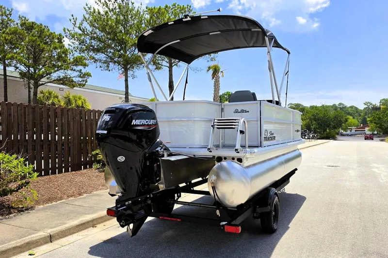 Slide: The Image of 2026 Sun Tracker Party Barge 18 DLX pontoon boat with Mercury engine on trailer. - 3