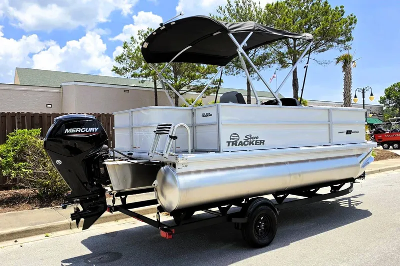 Slide: The Image of 2026 Sun Tracker Party Barge 18 DLX pontoon boat with Mercury engine on trailer. - 2