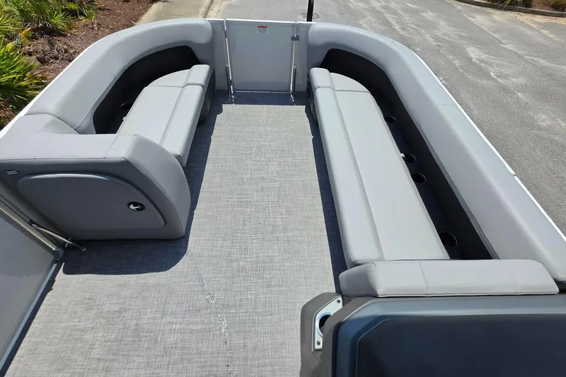 Slide: The Image of 2026 Sun Tracker Party Barge 18 DLX interior with gray seating and spacious layout. - 12