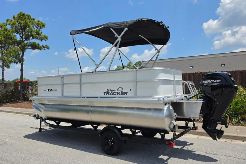 Slide: The Image of 2026 Sun Tracker Party Barge 18 DLX pontoon boat with Mercury outboard motor on trailer. - 8
