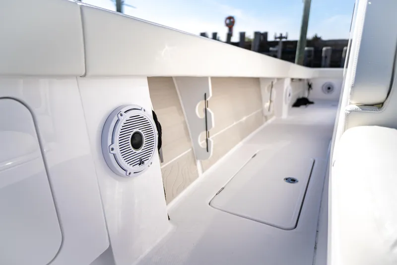 Slide: The Image of Interior view of a 2026 Jupiter 32 boat, featuring sleek white design and built-in speaker. - 10